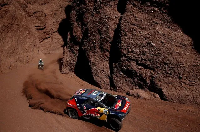 Carlos Sainz of Spain drives his Peugeot past Hans Smit of Netherlands on his Husqvarna motorcycle during the eighth stage in the Dakar Rally 2016 near Cafayate, Argentina, January 11, 2016. (Photo by Marcos Brindicci/Reuters)