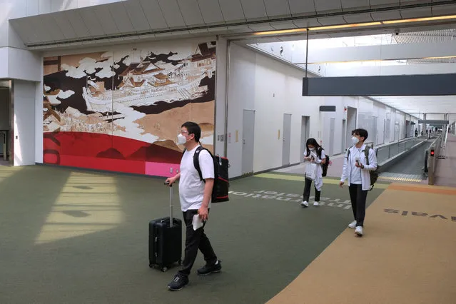 Artwork by Japanese painter Akira Yamaguchi titled “Imayou yuraku-zu” is displayed at Narita International Airport terminal 1 in Narita, Chiba prefecture on April 27, 2021, as part of the Look of the Games – the visual identity of the Tokyo 2020 Games to welcome athletes and Games stakeholders from around the world to Japan. (Photo by Kazuhiro Nogi/AFP Photo)