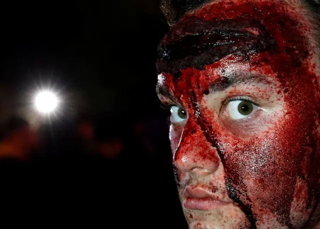 A participant in costume and make-up poses for a photo during a Halloween parade at Walibi park in Wavre, Belgium, October 31, 2018. (Photo by Yves Herman/Reuters)