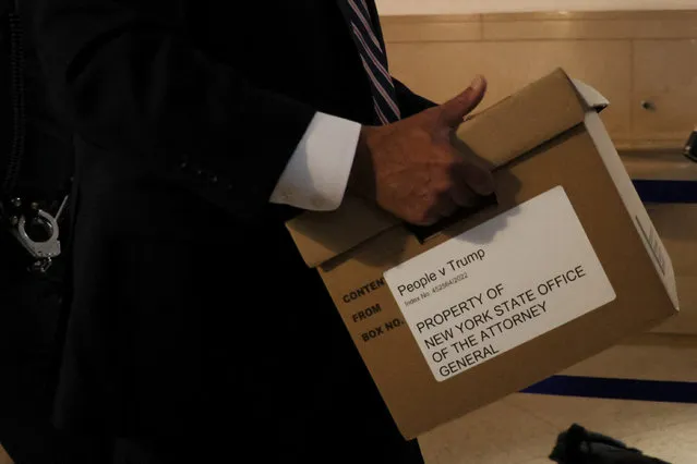 A box of evidence is carried at a Manhattan courthouse on the day former U.S. President Donald Trump attends the trial of himself, his adult sons, the Trump Organization and others in a civil fraud case brought by state Attorney General Letitia James, in New York City, U.S., October 2, 2023. (Photo by Brendan McDermid/Reuters)