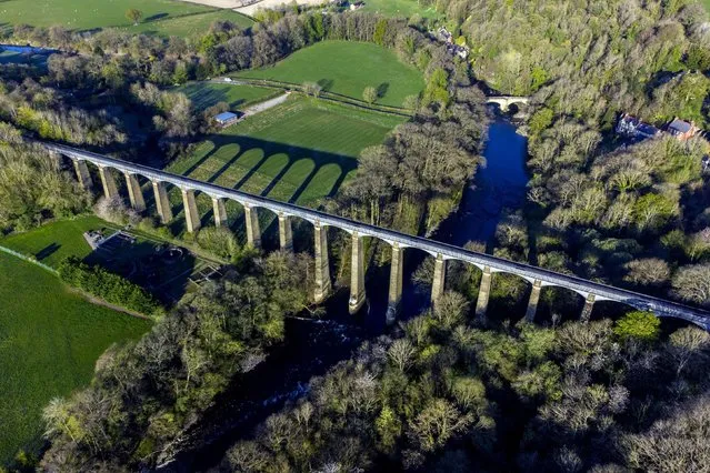 Early sun casts a long shadows at the Pontcysyllte aqueduct in Llangollen, United Kingdom on April 22, 2021 where visitors can take a horse-drawn boat over the River Dee. (Photo by Peter Byrne/PA Images via Getty Images)
