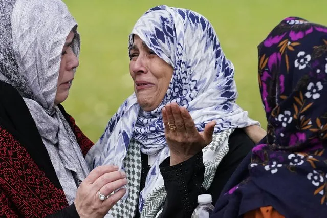 Muslim community members cry at the grave of Wadea Al Fayoume in LaGrange, Ill., Monday, October 16, 2023. An Illinois landlord accused of fatally stabbing the 6-year-old Muslim boy and seriously wounding his mother was charged with a hate crime after police and relatives said he singled out the victims because of their faith and as a response to the war between Israel and Hamas. (Phoot by Nam Y. Huh/AP Photo)