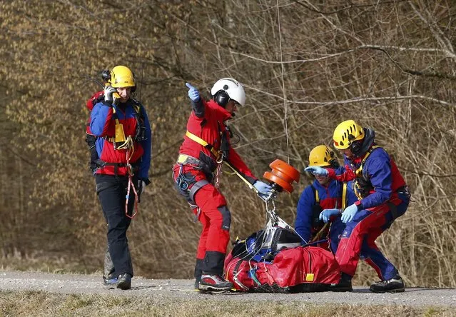 Members of emergency services prepare an injured person for transportation by helicopter from the site of the two crashed trains near Bad Aibling in southwestern Germany, February 9, 2016. Several people died after two trains collided in the southern German state of Bavaria on Tuesday, a police spokesman said, adding about 100 people were also injured. (Photo by Michael Dalder/Reuters)