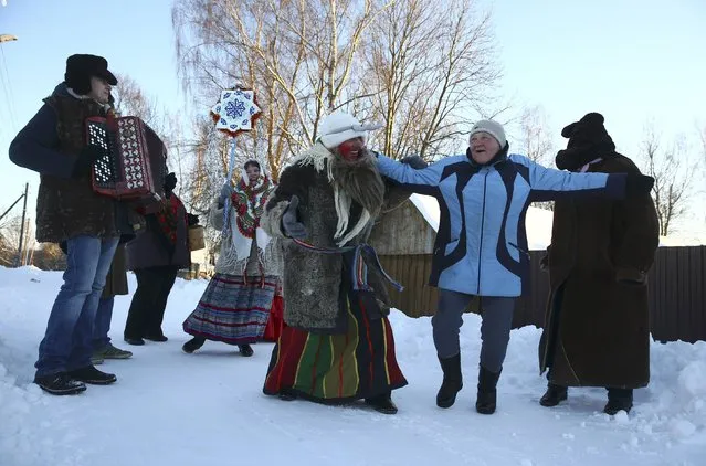 People celebrate the pagan rite called “Kolyadki”, a pagan winter holiday which over the centuries has merged with Orthodox Christmas celebrations in some parts of Belarus, in the village of Skirmantava, Belarus January 7, 2017. (Photo by Vasily Fedosenko/Reuters)