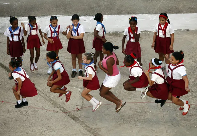 School children play with their teacher during recess at Martires de Tarara primary school in Havana,  November 2009. (Photo by Desmond Boylan/Reuters)