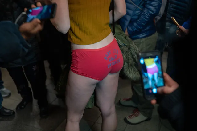 A woman is photographed by straphangers during the 18th annual No Pants subway ride on January 13, 2019 in New York City (Photo by David “Dee” Delgado/Getty Images)