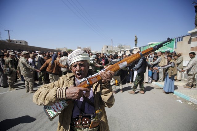 A Houthi militant carries his weapon during the funerals of Lutf al-Quhum, a prominent pro-Houthi religious singer, and a Houthi fighter, in Yemen's capital Sanaa, February 18, 2016. The two men were reportedly killed during fighting against pro-government forces in the country's central province of Marib. (Photo by Mohamed al-Sayaghi/Reuters)