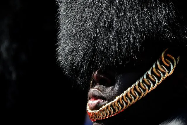 A soldier of the Buckingham Palace guards, stands in the sun in his full gear as temperatures were expected to reach nearly 30 degrees centigrade in London, Wednesday, September 8, 2021. (Photo by Frank Augstein/AP Photo)