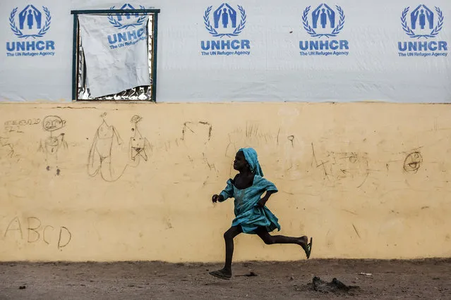 A girl runs at Malkohi refugee camp in Jimeta, Adamawa State, Nigeria on February 19, 2019, four days ahead of the country's General elections set for February 23 after a last-minute rescheduling. Malkohi is a camp for internal displaced who fled their homes as Boko Haram insurgents advanced across north-eastern Nigeria. From their homes on the outskirts of Yola, capital of presidential candidate Atiku Abubakar's home state Adamawa, Malkohi residents say they feel forgotten. (Photo by Luis Tato/AFP Photo)