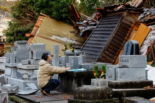 A man who lost his house reacts as he visits the graves of his parents, which were rattled by the earthquake, in Wajima, Japan on January 4, 2024. (Photo by Kim Kyung-Hoon/Reuters)