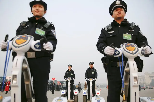Police officers secure the area around the Great Hall of the People in Beijing after the opening session of the Chinese People's Political Consultative Conference (CPPCC) in Beijing, China, March 3, 2016. (Photo by Damir Sagolj/Reuters)