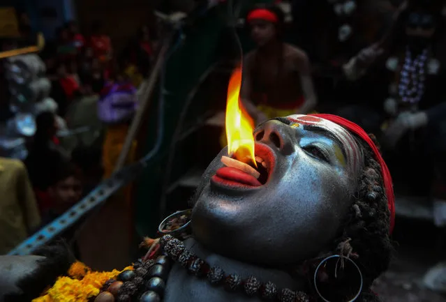 An indian artist, dressed as hindu God Shiva, performs during Maha ShivaRatri festival,celebrated in reverence of the God Shiva,married to Hindu Goddess Parvati, in the old city of Allahabad on March 4,2019. Hindu devotees mark the Maha Shivaratri festival by offering special prayers and fasting to worship the deity Shiva. (Photo by Ritesh Shukla/NurPhoto via Getty Images)