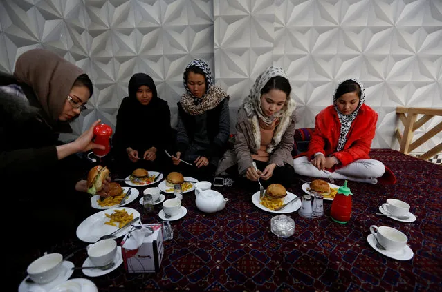 Sima Azimi (L), 20, a trainer at the Shaolin Wushu club, eats lunch with her students at a restaurant in Kabul, Afghanistan February 2, 2017. (Photo by Mohammad Ismail/Reuters)