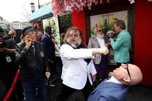 Cast member Jack Black pretends to punch director Mike Mitchell as they attend a premiere of the film “Kung Fu Panda 4” in Los Angeles on March 3, 2024. (Photo by Mario Anzuoni/Reuters)