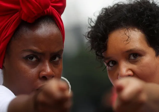 Women perform during the Afro female block Ilu Oba de Min as people march during the National Black Consciousness Day in Sao Paulo, Brazil on November 20, 2021. (Photo by Amanda Perobelli/Reuters)