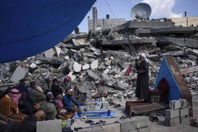 Palestinians pray in front of a mosque destroyed by the Israeli airstrikes in Rafah, Gaza Strip, Friday, March 8, 2024, ahead of the holy Islamic month of Ramadan. (Photo by Fatima Shbair/AP Photo)