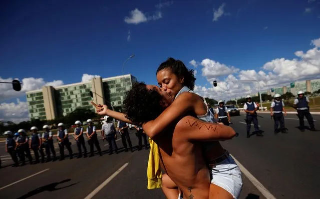 University students kiss as they protest against cuts to federal spending on higher education in Brasilia, Brazil, Wednesday, May 15, 2019. (Photo by Adriano Machado/Reuters)