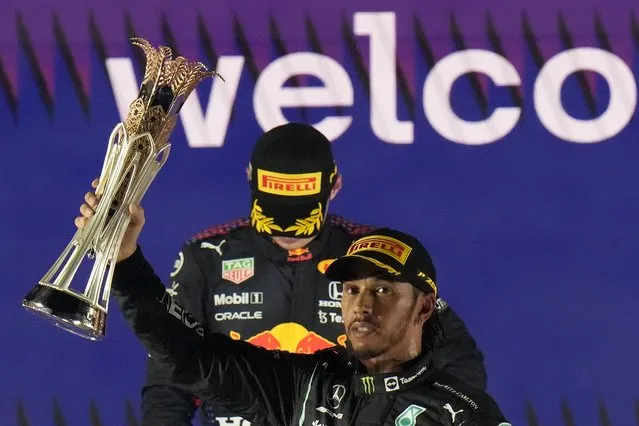 Mercedes driver Lewis Hamilton of Britain celebrates winning the Formula One Saudi Arabian Grand Prix in front of the second placed Red Bull driver Max Verstappen of the Netherlands, in Jiddah, Sunday, December 5, 2021. (Photo by Hassan Ammar/AP Photo)
