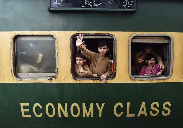 Children wave from a train as they prepare to travel to their homes to celebrate Eid al-Fitr, in Karachi, Pakistan, 07 April 2024. Eid al-Fitr is an Islamic holiday that marks the end of Ramadan, and is celebrated during the first three days of Shawwal, the 10th month of the Islamic calendar. It is expected to begin on 10 or 11 April 2024, depending on the lunar calendar. The Muslims' holy month of Ramadan is the ninth month in the Islamic calendar and it is believed that the revelation of the first verse in the Koran was during its last 10 nights. It is celebrated yearly by praying during the night time and abstaining from eating, drinking, and sexual acts during the period between sunrise and sunset. It is also a time for socializing, mainly in the evening after breaking the fast and a shift of all activities to late in the day in most countries. (Photo by Shahzaib Akber/EPA/EFE)