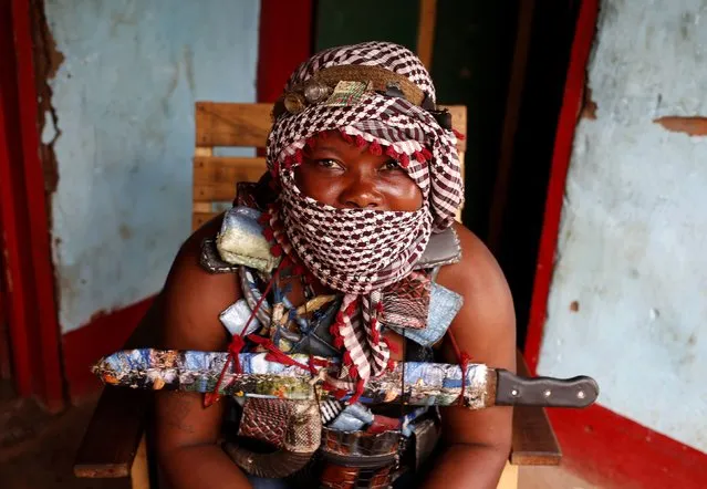 A masked female member of the anti-balaka, a Christian militia, sits in the village of Zawa, April 8, 2014. (Photo by Goran Tomasevic/Reuters)