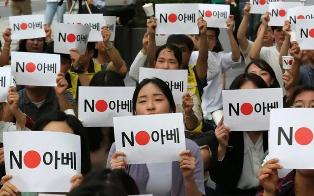 Japanese embassy in Seoul, South Korea, Thursday, July 18, 2019. The signs read: “No Abe (Japanese Prime Minister Shinzo Abe)”. (Photo by Ahn Young-joon/AP Photo)