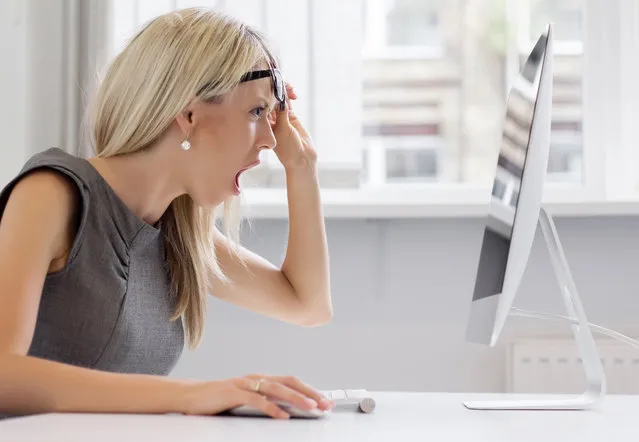 Shocked woman looking at computer screen with totally surprised look. (Photo by Grinvalds/Getty Images)