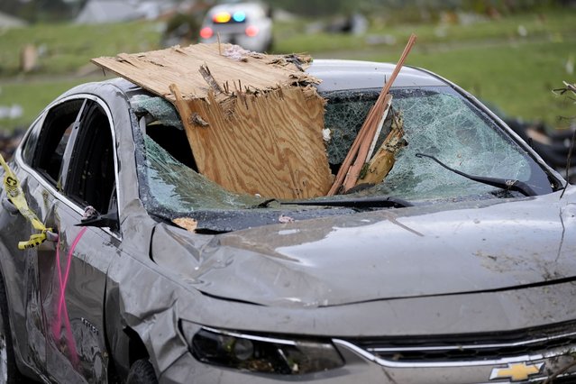 A damaged car sits on a street after a tornado Tuesday, May 21, 2024, in Greenfield, Iowa. (Photo by Charlie Neibergall/AP Photo)
