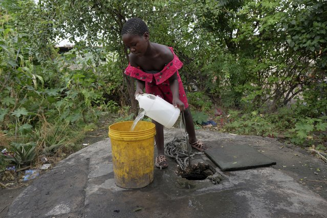 A young girl fetches water from a well in Lilanda township in Lusaka, Zambia, Saturday March 9, 2024. Lilanda, an impoverished township on the edge of the Zambian capital of Lusaka, is a typical cholera hotspot. Stagnant pools of water dot the dirt roads. Clean water is gold dust. Extreme weather events have hit parts of Africa relentlessly in the last three years, with tropical storms, floods and drought causing crises of famine and displacement, and leaving another deadly threat in their aftermath: some of the continent's worst outbreaks of cholera. (Photo by Tsvangirayi Mukwazhi/AP Photo)