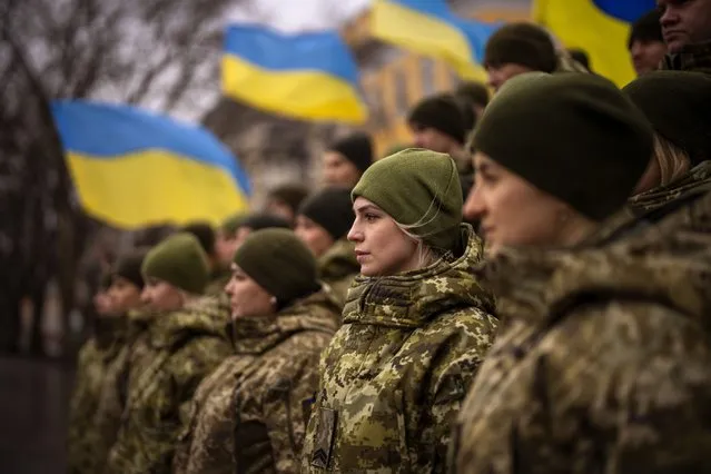 Ukrainian Army soldiers pose for a photo as they gather to celebrate a Day of Unity in Odessa, Ukraine, Wednesday, February 16, 2022. As Western officials warned a Russian invasion could happen as early as today, the Ukrainian President Zelenskyy called for a Day of Unity, with Ukrainians encouraged to raise Ukrainian flags across the country. (Photo by Emilio Morenatti/AP Photo)