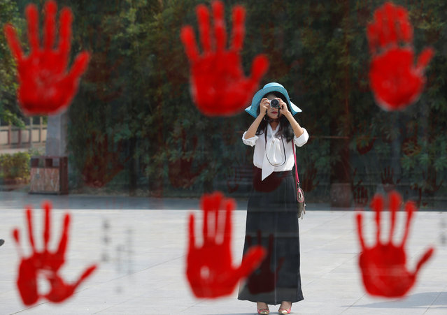 A visitor takes a picture of a display bearing hand prints of war heroes from the War of Resistance against Japan, at Jianchuan Museum Cluster in Anren, Sichuan Province, China, May 13, 2016. (Photo by Kim Kyung-Hoon/Reuters)