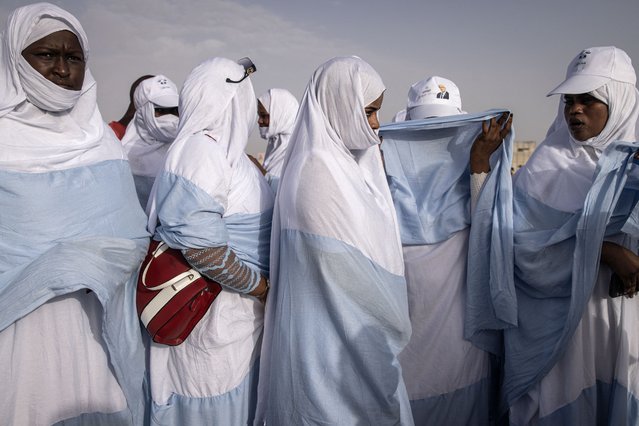 Supporters of the President of Mauritania and leader of the Union for the Republic Mohamed Ould Ghazouani gather during the final campaign rally in Nouakchott on June 27, 2024. Seven candidates are running in Mauritania's presidential election on June 29, with incumbent Mohamed Ould Cheikh El Ghazouani the favourite to win a second term at the head of the vast West African nation. (Photo by John Wessels/AFP Photo)