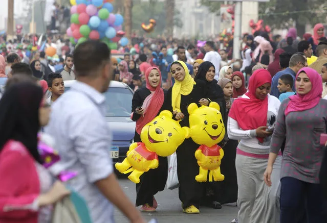 Egyptians celebrate Eid al-Fitr, marking the end of the Muslim holy month of Ramadan in Cairo, Egypt, Friday, July 17, 2015. (Photo by Amr Nabil/AP Photo)