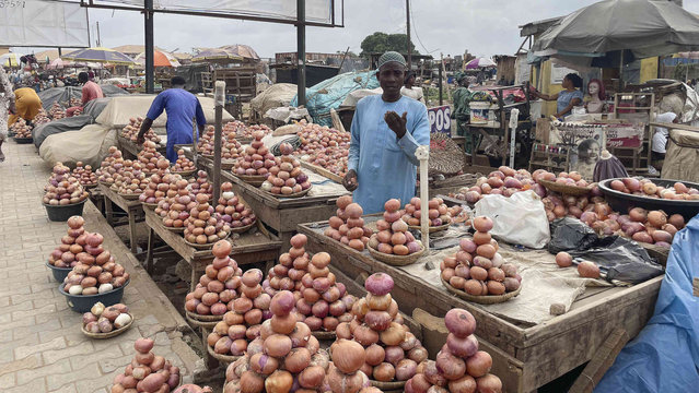 A man sell onions on the street in Ibadan, Southwest Nigeria, Wednesday, May 29, 2024. (Photo by Sunday Alamba/AP Photo)