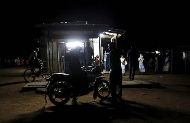 A motorcyclist fuels his bike at a station within the trading centre in the village of Kogelo, west of Kenya's capital Nairobi, July 15, 2015. (Photo by Thomas Mukoya/Reuters)
