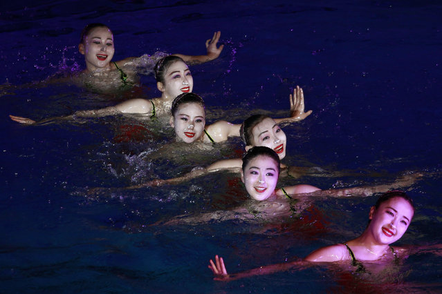 A group of synchronized swimmers perform celebrating the Day of Shining Star on the occasion of the 80th birth anniversary of former North Korean leader Kim Jong Il at the swimming gymnasium in Pyongyang, North Korea, Sunday, February 13, 2022. (Photo by Cha Song Ho/AP Photo)