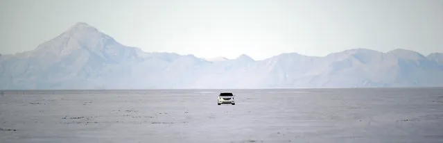 In this Monday, July 20, 2015 photo, a car drives across the Bonneville Salt Flats in Utah. (Photo by Rick Bowmer/AP Photo)