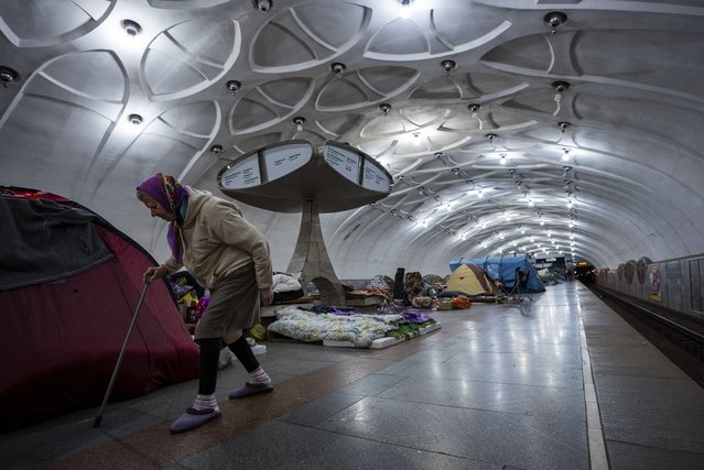 An elderly woman walks inside a metro station being used as a bomb shelter in Kharkiv, Ukraine, Thursday, May 12, 2022. (Photo by Mstyslav Chernov/AP Photo)