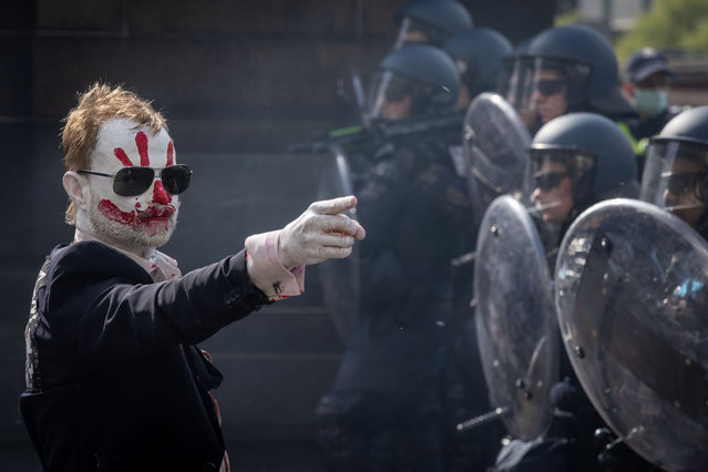 A protester gestures towards police officers on Spencer Street on September 11, 2024 in Melbourne, Australia. Anti-war protesters in Melbourne are planning to disrupt the upcoming Land Forces International Defence Expo by blocking streets and staging peaceful demonstrations, with estimates of up to 25,000 participants. Activist groups, including Students for Palestine and Disrupt Wars, aim to obstruct the expo's opening on Wednesday, claiming they have already halted weapon deliveries during a prior blockade, while police have increased their presence and established a fortified perimeter around the event site to manage potential chaos. (Photo by Darrian Traynor/Getty Images)