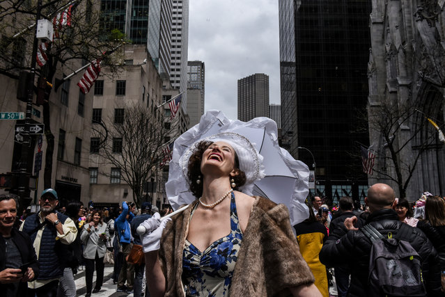 A woman reacts to the sun coming out of the clouds during the annual Easter Parade and Bonnet Festival on Fifth Avenue in New York City, New York, U.S. April 21, 2019. (Photo by Stephanie Keith/Reuters)