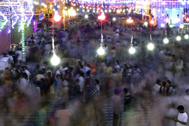 Devotees gather to take part in the celebrations to mark the Krishna Janmashtami festival at a temple in Jalandhar on August 26, 2024. (Photo by Shammi Mehra/AFP Photo)