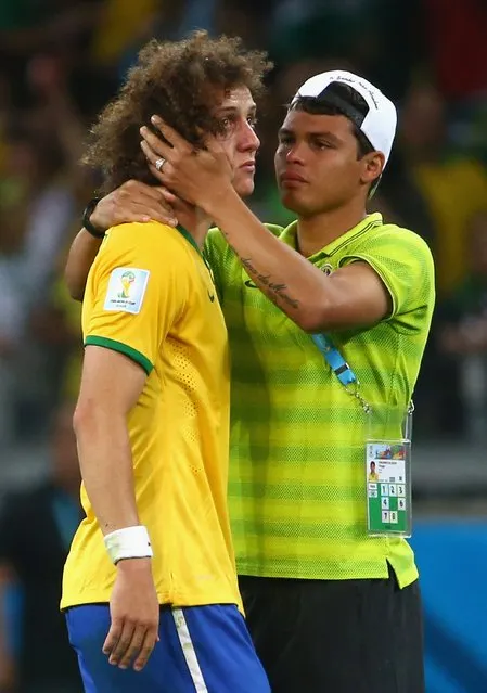 Thiago Silva of Brazil (R) consoles teammate David Luiz after Germany's 7-1 victory during the 2014 FIFA World Cup Brazil Semi Final match between Brazil and Germany at Estadio Mineirao on July 8, 2014 in Belo Horizonte, Brazil. (Photo by Robert Cianflone/Getty Images)