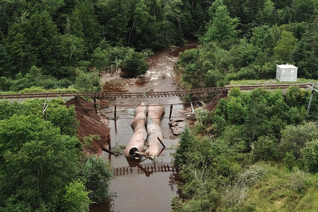 Water flows through a washed-out culvert on the main CN Rail line which leads to the port of Halifax, after the heaviest rain to hit the Atlantic Canadian province of Nova Scotia in more than 50 years triggered floods, in Truro, Nova Scotia, Canada on July 23, 2023. (Photo by Nigel Gloade/Millbrook First Nations/Handout via Reuters)