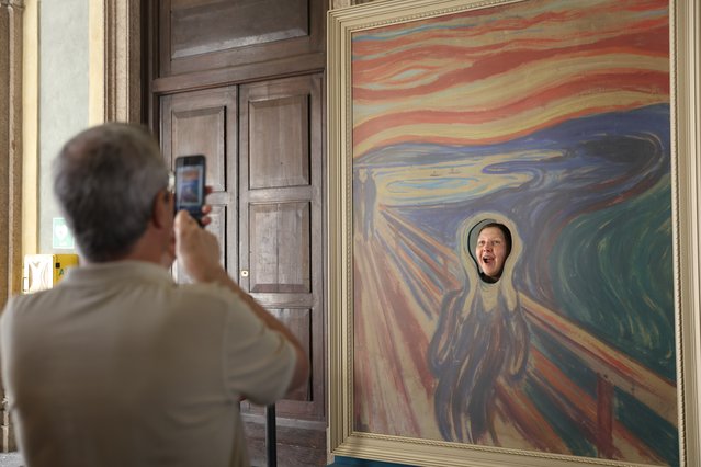 A visitor poses by an installation inspired by The Scream by Edvard Munch on September 23, 2024. The Royal Palace of Milan is holding an exhibition of work by the Norwegian painter. (Photo by Xinhua News Agency/Rex Features/Shutterstock)