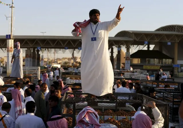 A vendor selling dates on a pick-up truck shouts to attracts customers during the annual dates festival in Berida of the Saudi central province of Qassim August 14, 2015. (Photo by Faisal Al Nasser/Reuters)