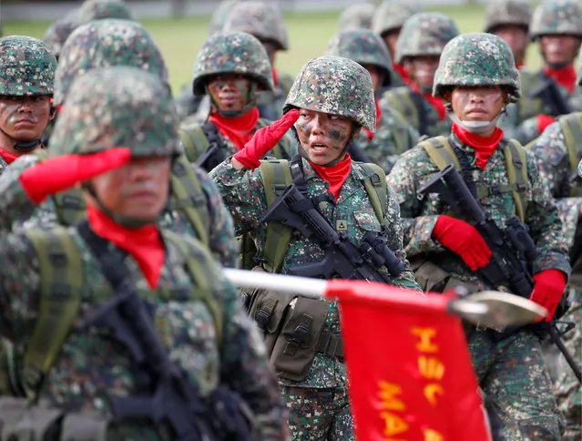 Soldiers take part in a military parade to honour President Benigno Aquino, a few days before he leaves office for incoming President-elect Rodrigo Duterte at the military's main Camp Aguinaldo in Quezon city, Metro Manila, Philippines June 27, 2016. (Photo by Erik De Castro/Reuters)