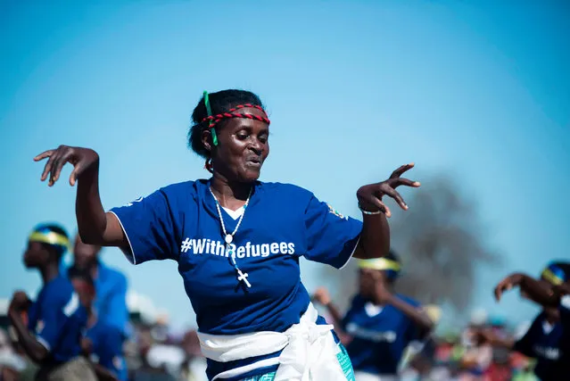 Mozambican refugees perform a traditional Muchongoyo dance during belated World Refugee Day commemorations at Tongogara Refugee Camp in Chipinge, Manicaland Province, Eastern Zimbabwe, on August 2, 2017. Tongogora, being Zimbabwe' s main refugee camp, has seen its population of refugees from several African countries rise from an average of about 3000 in the past years to 10000, according to media reports. The camp had initially been established for refugees from Mozambique in 1984. (Photo by Zinyange Auntony/AFP Photo)