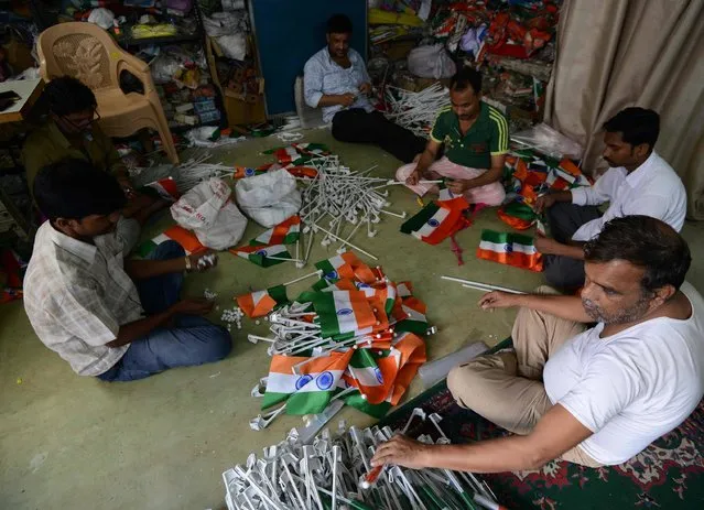 Indian workers prepare Indian national flags for the upcoming India's Independence day celebrations at a workshop in New Delhi on August 3, 2017. Independence day is celebrated every year across India on August 15th to commemorate the independence from the United Kingdom on August 15, 1947. (Photo by Money Sharma/AFP Photo)