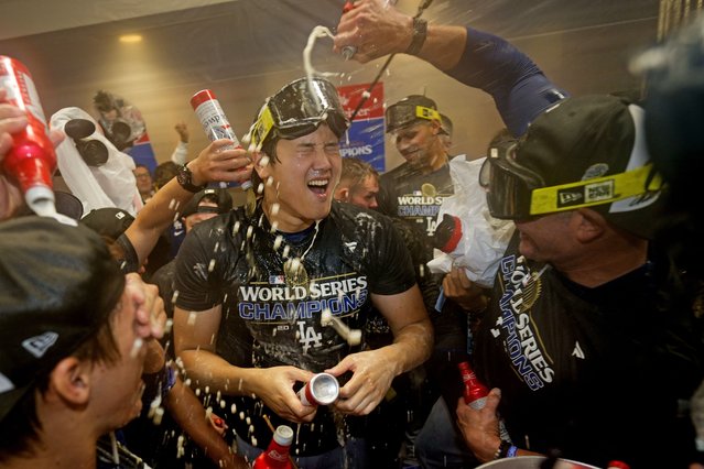Los Angeles Dodgers' Shohei Ohtani celebrates in the locker room after their win against the New York Yankees in Game 5 to win the baseball World Series, Thursday, October 31, 2024, in New York. (Photo by Ashley Landis/AP Photo)
