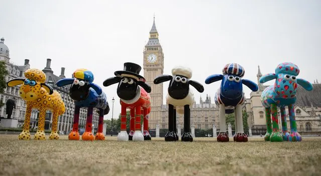 A selection of Shaun the Sheep figures, decorated by artists and celebrities, are displayed in Parliament Square, central London, England on August 7, 2014.  Sixty of the sheep figures are set to be placed around London and Bristol in March 2015, as part of the “Shaun in the City” art trail project. The figures will then be auctioned in aid of children's hospital charities in the autumn of 2015. (Photo by Leon Neal/AFP Photo)