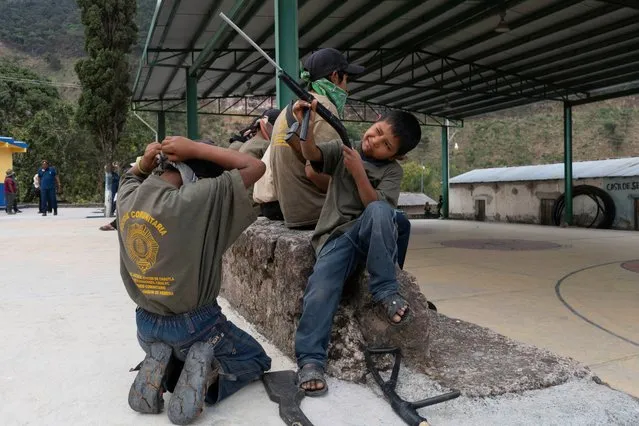 Children with toy and real guns, demonstrate newly learnt skills from military-style weapons training, to a Reuters journalist in Ayahualtempa, Mexico, February 3, 2020. (Photo by Alexandre Meneghini/Reuters)